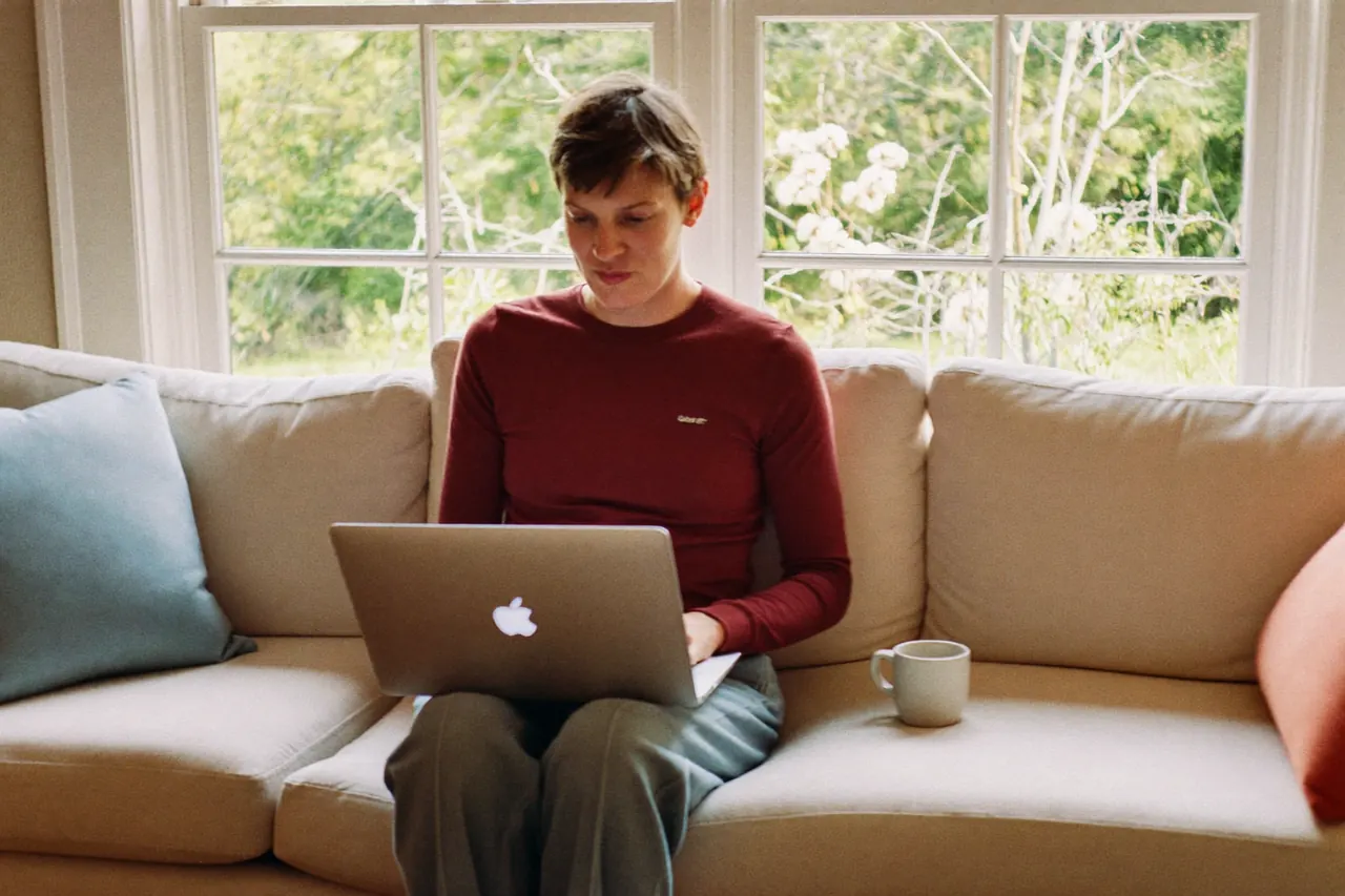 Homeowner checking window funding eligibility on a laptop at home